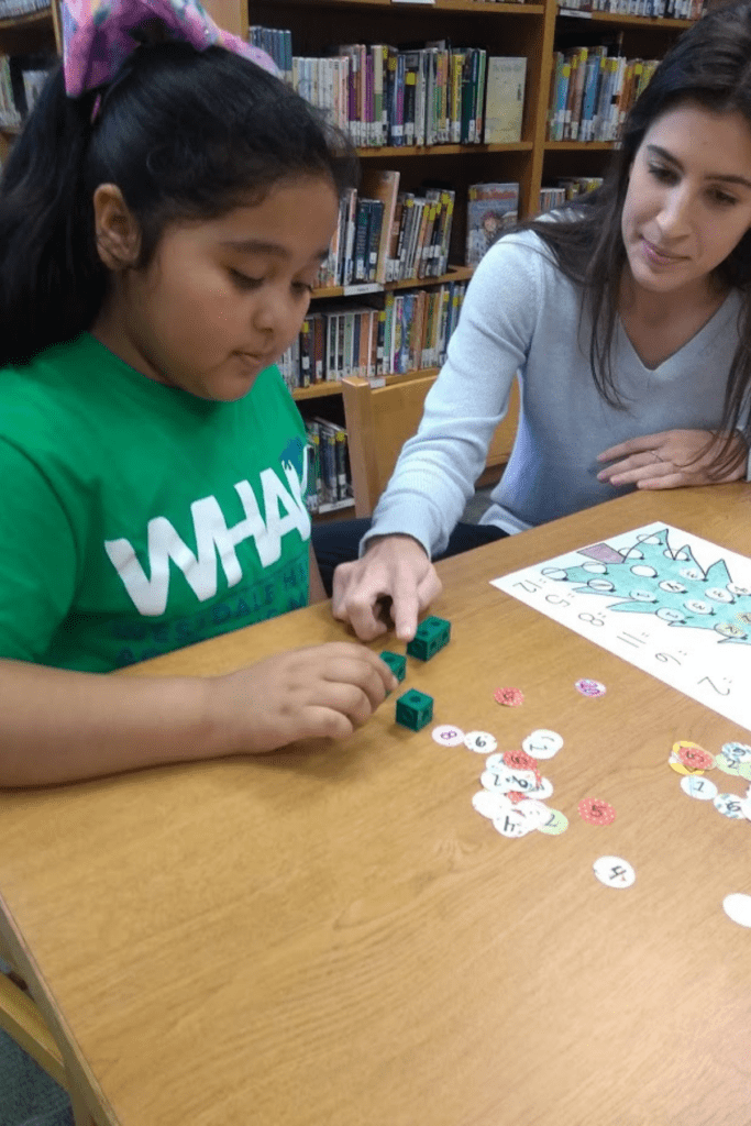Math friend helping child during EveryOne Counts session